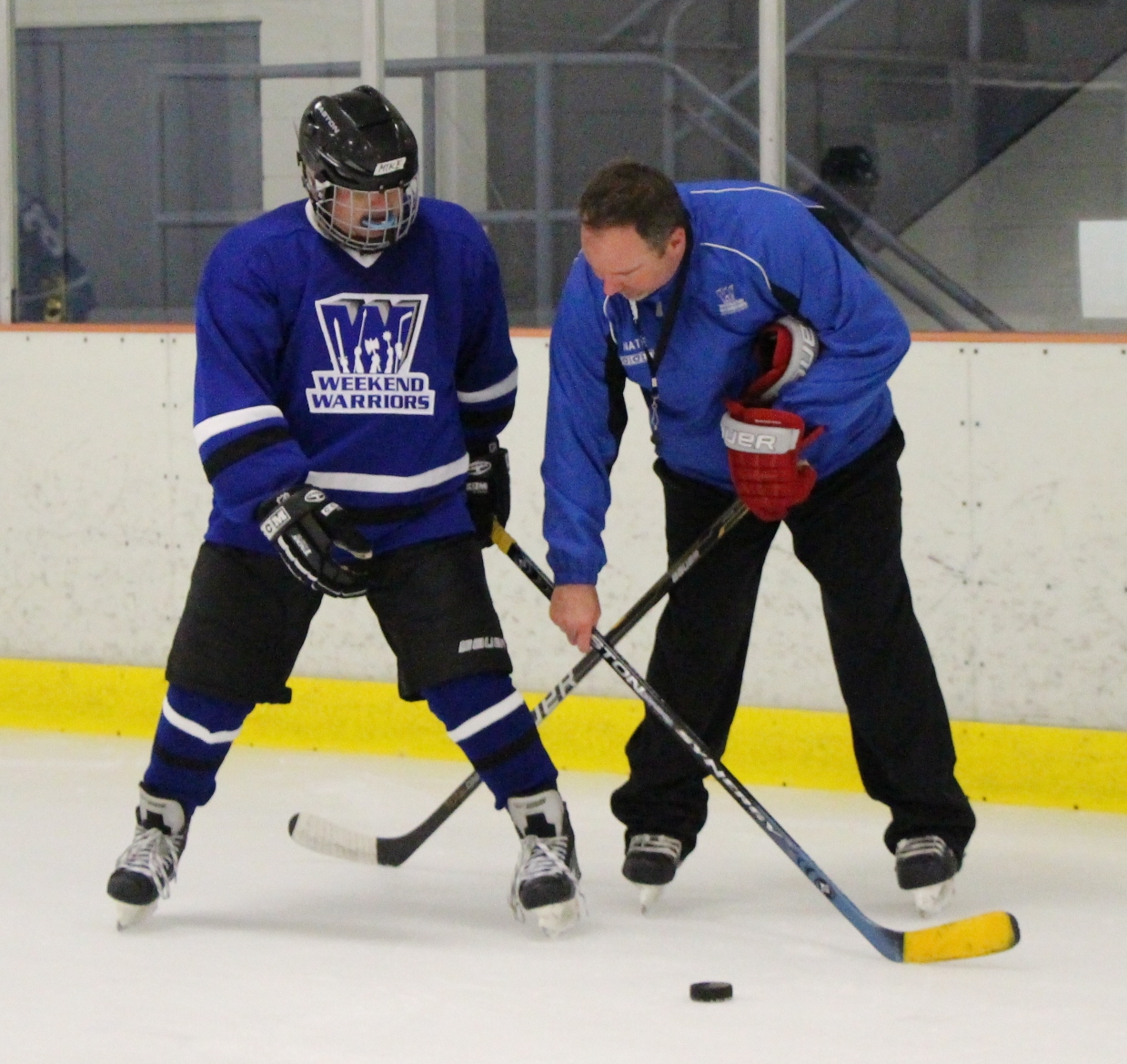 Coach Nate helps a player with stick handling